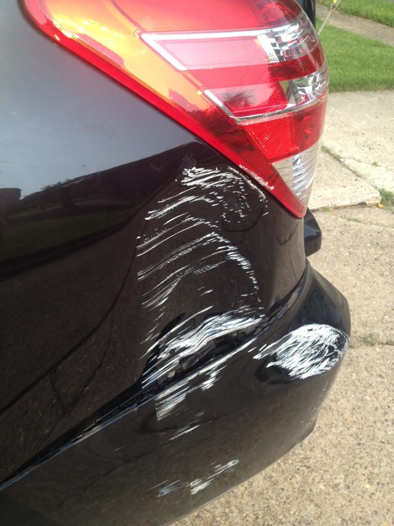 a severely dented and scraped car