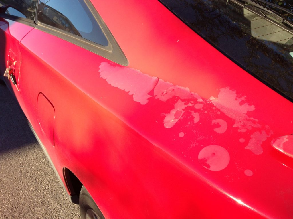 blistering, bubbling clear coat flaking off a red car